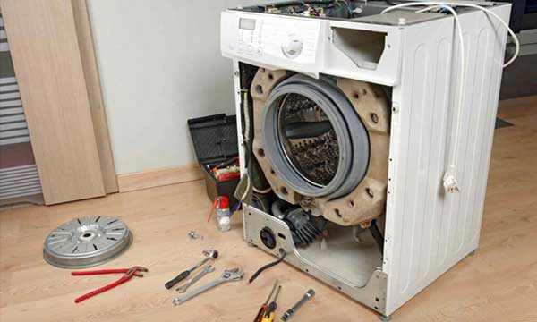 Certified technician repairing a washing machine at a home in Nairobi, Kenya